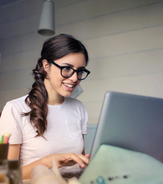 A woman looking at a laptop